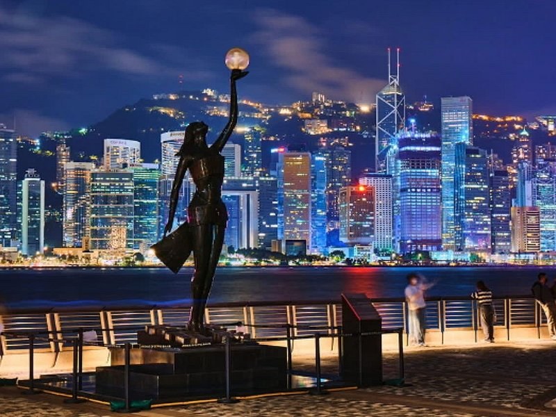 The Avenue of Stars on the Kowloon waterfront at night with the harbour lit behind